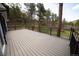 Spacious outdoor deck with black railing and view of the surrounding trees and landscape, perfect for entertaining at 14546 Pine View Rd, Larkspur, CO 80118