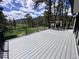 Expansive outdoor deck with black metal railings, offering scenic views of the surrounding landscape at 14546 Pine View Rd, Larkspur, CO 80118