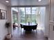 Well-lit dining area with large windows showcasing an outdoor view, complete with sleek black table set at 14546 Pine View Rd, Larkspur, CO 80118