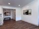 Elegant entryway with wood floors, neutral paint, stylish bench, and sophisticated artwork on the walls at 14546 Pine View Rd, Larkspur, CO 80118