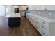 Bright kitchen with white cabinetry, quartz countertops, stainless appliances, and a large island at 14546 Pine View Rd, Larkspur, CO 80118
