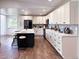 Modern kitchen featuring white cabinets, a contrasting dark island, and sleek countertops at 14546 Pine View Rd, Larkspur, CO 80118