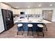 Bright kitchen with white cabinets, stainless steel appliances, and a spacious island at 14546 Pine View Rd, Larkspur, CO 80118