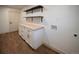 Laundry room with butcher block countertop, modern cabinets and shelving at 14546 Pine View Rd, Larkspur, CO 80118