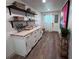 Functional laundry room with bright cabinets, butcher block counters, ample storage, and stylish decor at 14546 Pine View Rd, Larkspur, CO 80118