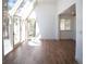 Sunlit living room featuring hardwood floors, large windows, and access to an outdoor deck at 14546 Pine View Rd, Larkspur, CO 80118