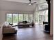 Bright living room with vaulted ceilings, wood floors, many windows and beautiful views to the outside at 14546 Pine View Rd, Larkspur, CO 80118