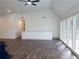 Spacious living area with wood flooring, a ceiling fan, and plenty of natural light at 14546 Pine View Rd, Larkspur, CO 80118