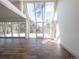 Bright living room with hardwood floors and large windows showcasing the outdoor scenery at 14546 Pine View Rd, Larkspur, CO 80118