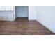 Open living space with hardwood floors, light walls, and connection to the kitchen at 14546 Pine View Rd, Larkspur, CO 80118