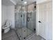 Stylish, modern glass shower with black hardware and gray tiled surround at 14546 Pine View Rd, Larkspur, CO 80118