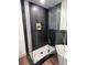 Walk-in shower featuring sleek black tile, a rainfall showerhead, and modern design at 14546 Pine View Rd, Larkspur, CO 80118