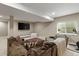 A spacious basement featuring plush seating, a large TV, and a window for natural light at 7734 Blue Water Dr, Castle Rock, CO 80108