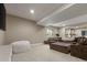 A comfortable basement with plush seating, a large TV, and plenty of space for relaxing at 7734 Blue Water Dr, Castle Rock, CO 80108