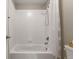 A clean bathroom featuring a white tiled shower-tub combination with a shower curtain at 7734 Blue Water Dr, Castle Rock, CO 80108