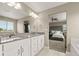 Bright primary bathroom with dual sinks, granite countertops, and en-suite access to the main bedroom at 7734 Blue Water Dr, Castle Rock, CO 80108