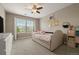 A bright bedroom featuring a neutral color palette, with a comfortable bed and natural light at 7734 Blue Water Dr, Castle Rock, CO 80108