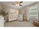 Charming Bedroom with a white crib, comfortable chair, soft rug, and bright natural light at 7734 Blue Water Dr, Castle Rock, CO 80108