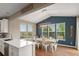 Eat-in dining area features modern chandelier, blue accent wall, and lots of natural light from many windows at 7734 Blue Water Dr, Castle Rock, CO 80108