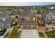 Beautiful two-story home boasts a three-car garage, landscaped yard, and mountain views at 7734 Blue Water Dr, Castle Rock, CO 80108