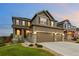 Attractive home featuring a three-car garage, covered porch, and landscaped front yard at 7734 Blue Water Dr, Castle Rock, CO 80108