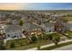 Aerial view of a neighborhood with well-maintained homes, lush landscaping, and a serene setting at 7734 Blue Water Dr, Castle Rock, CO 80108