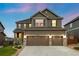 Charming two-story home with a three-car garage and well-manicured lawn at 7734 Blue Water Dr, Castle Rock, CO 80108
