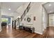 Open foyer with a staircase, hardwood floors, and stylish decor at 7734 Blue Water Dr, Castle Rock, CO 80108