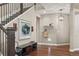 Elegant foyer with hardwood floors, staircase, and decorative accents at 7734 Blue Water Dr, Castle Rock, CO 80108