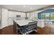 Spacious kitchen with white cabinets, large island, and modern appliances at 7734 Blue Water Dr, Castle Rock, CO 80108