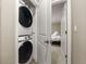 Convenient laundry area with a stacked washer and dryer and access to the bedroom at 7734 Blue Water Dr, Castle Rock, CO 80108