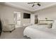 Well-lit primary bedroom featuring a king-size bed, tray ceiling, and en-suite bathroom access at 7734 Blue Water Dr, Castle Rock, CO 80108