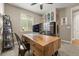 Home office with unique wood desk, metal chairs, and a display of skateboards and other decorative objects at 7734 Blue Water Dr, Castle Rock, CO 80108