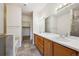 Primary bathroom featuring double sinks and a walk-in closet at 10725 Eliot Cir # 102, Denver, CO 80234
