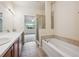 Primary bathroom featuring double sinks, walk-in shower, and a bath tub at 10725 Eliot Cir # 102, Denver, CO 80234