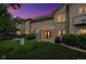 Beautiful condo featuring well-maintained lawns, stone accents, and a delightful outdoor space, lit up at night at 10725 Eliot Cir # 102, Denver, CO 80234