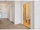Hallway featuring neutral tones, closet, and bathroom with tiled floors and glass door shower at 10725 Eliot Cir # 102, Denver, CO 80234