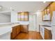 Cozy kitchen featuring wood cabinets, white countertops, and modern appliances at 10725 Eliot Cir # 102, Denver, CO 80234