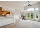 Bright living room featuring high ceilings, a ceiling fan, and sliding glass doors to the outdoor space at 10725 Eliot Cir # 102, Denver, CO 80234