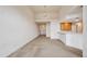 Open-concept living area with vaulted ceilings, light fixtures, and a kitchen bar counter at 10725 Eliot Cir # 102, Denver, CO 80234