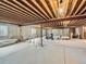 Unfinished basement featuring exposed ceiling beams, concrete flooring, and potential for customization at 15955 W 52Nd Dr, Golden, CO 80403