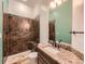 Stylish bathroom featuring a tiled shower and single sink vanity at 15955 W 52Nd Dr, Golden, CO 80403