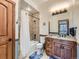 Cozy bathroom featuring a tub with tiled walls, wooden vanity, and modern lighting at 15955 W 52Nd Dr, Golden, CO 80403