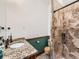 Bathroom featuring a granite countertop, wooden trim, tiled shower, and fixtures at 15955 W 52Nd Dr, Golden, CO 80403