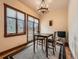 Charming breakfast nook with rustic wood trim, natural light, and decorative chandelier at 15955 W 52Nd Dr, Golden, CO 80403