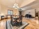 Formal dining room featuring hardwood floors, elegant chandelier, dining table with seating, and open floor plan at 15955 W 52Nd Dr, Golden, CO 80403