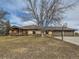 Ranch-style house featuring a front lawn with a basketball hoop and a three-car garage at 15955 W 52Nd Dr, Golden, CO 80403