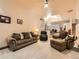 Comfortable living room with plush seating, soft carpeting, warm lighting, and a ceiling fan at 15955 W 52Nd Dr, Golden, CO 80403