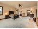 Spacious main bedroom with large bed, ceiling fan, and en-suite bathroom at 15955 W 52Nd Dr, Golden, CO 80403