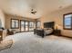 Spacious main bedroom featuring a ceiling fan, large windows, and a door to the outside at 15955 W 52Nd Dr, Golden, CO 80403